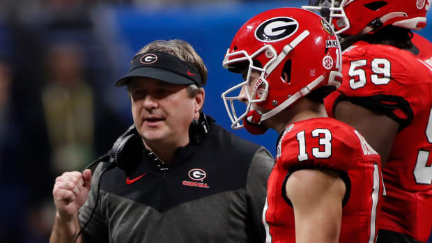 Georgia coach Kirby Smart speaks with Georgia quarterback Stetson Bennett (13) during the second half of the Chick-fil-A Peach Bowl NCAA College Football Playoff semifinal game between Ohio State and Georgia on Saturday, Dec 31, 2022, in Atlanta.